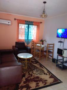 a living room with a couch and a table at La casa in Kribi