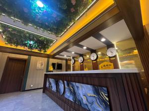 a row of clocks on the wall in a lobby at HH Inn in Lagos