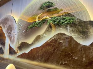 a painting of a waterfall with trees on it at HH Inn in Lagos