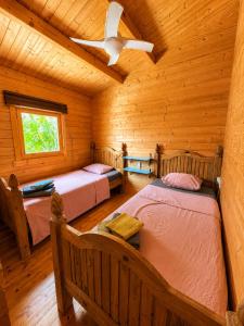 a bedroom with two beds in a wooden cabin at Finca Mariposa Mariposaholidays in Nerja +25 photos