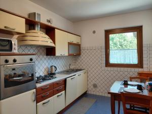 a kitchen with a sink and a stove top oven at B&B Piazza Marconi in Castelpizzuto