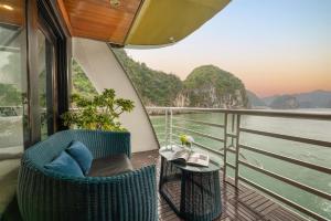 a balcony with two chairs and a table on a boat at Beka Travel Cruise in Cat Ba