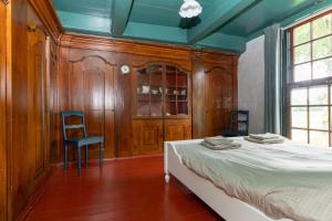 a bedroom with a bed and two chairs in it at De Boerstee in Ruinerwold