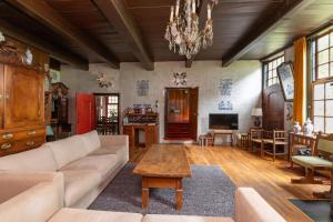 a living room with a couch and a table at De Boerstee in Ruinerwold