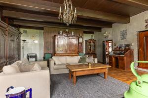 a living room with a couch and a table at De Boerstee in Ruinerwold