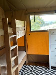 a room with two bunk beds and a window at Ecosse Glamping in Crossford