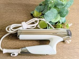 a hair dryer sitting on a table next to a plant at Norah Stay Tokyo in Yashio