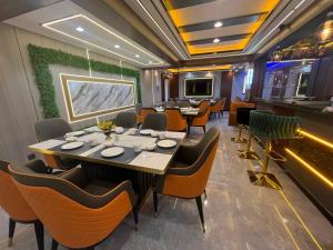 a restaurant with tables and chairs in a room at HH Inn in Lagos
