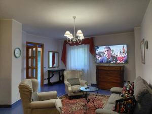 a living room with a couch and a tv at B&B Piazza Marconi in Castelpizzuto