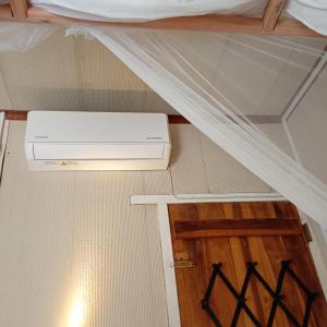 a room with a bed with a heater on the floor at Salt Bay Kite and Dive Resort in Kalpitiya