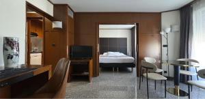 a room with a bedroom with a bed and chairs at Goldstar Resort & Suites in Nice +51 photos