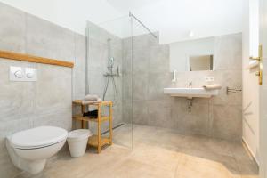 a bathroom with a toilet and a sink and a shower at Kaiser's Hof in Strass +50 photos