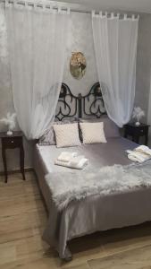 a bedroom with a bed with white curtains at La Suite nella Valle in Trecchina