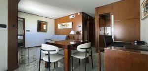a room with a table and some white chairs at Goldstar Resort & Suites in Nice