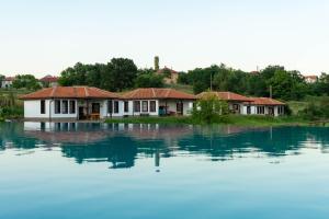 a row of houses sitting on top of a large body of water at Yagnevo Complex in Yagnevo