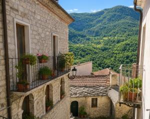 a view from an alley of buildings with potted plants at B&B Piazza Marconi in Castelpizzuto