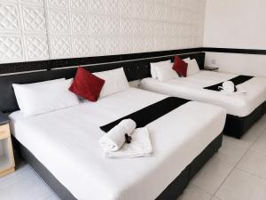 two beds in a room with white and red pillows at Laletsa Lodge in Durban +53 photos