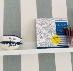 a shelf with a coloring book and a box on it at Gigi La Roza in Perros-Guirec