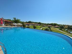 a large blue swimming pool in a resort at Yagnevo Complex in Yagnevo