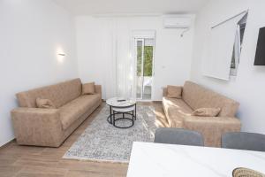 a living room with two couches and a table at Babulje in Ulcinj