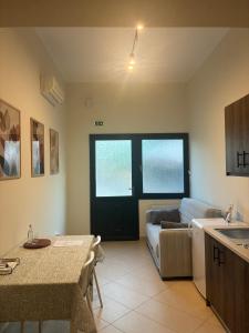 a kitchen and living room with a couch and a table at Two Mills Apartments in Myrina