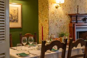 a dining room with a table with wine glasses at Tweeddale Arms Hotel in Gifford