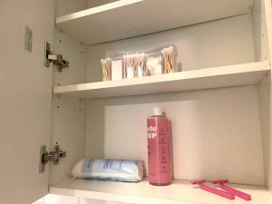 a pink bottle sitting on a shelf in a bathroom at Museums Quartier 0608 in Vienna