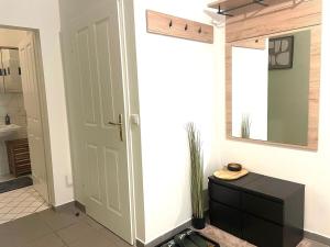a hallway with a bathroom with a door and a mirror at Museums Quartier 0608 in Vienna +21 photos