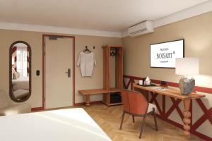 a bedroom with a mirror and a desk and a chair at Hôtel de l'Europe by HappyCulture in Strasbourg