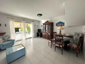 a living room with a blue couch and a table at Adosado Mar i Pins in Benicarló