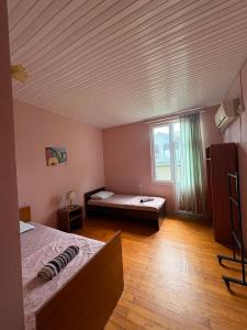 a large room with two beds and a window at hotel shomari in Grigoleti +10 photos