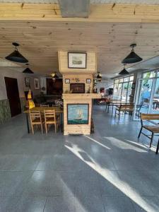a room with a fireplace and a table and chairs at hotel shomari in Grigoleti