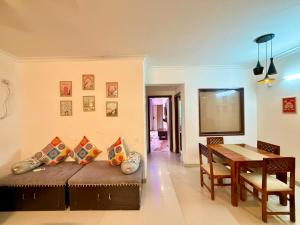 a living room with a couch and a table at Aloha Serenity By Evara -Ganga View Stays in Rishīkesh
