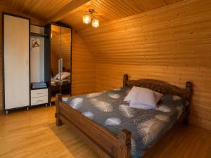 a bedroom with a bed in a wooden cabin at Mountain House in Mykulychyn
