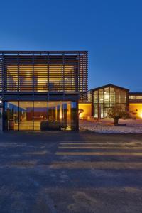 a large building with a lot of windows at night at La Fleur de Boüard in Néac