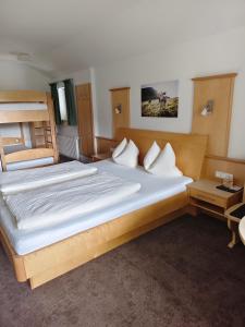 a bedroom with two beds and a bunk bed at Appartements Bergsonne in Westendorf