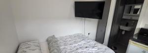 a living room with a couch and a flat screen tv at lovely Studio Flat in The Hyde