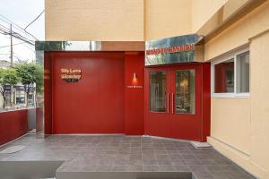 a red front door of a building with a restaurant at Monday Mansion Hotel in Seoul