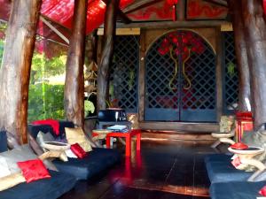 a living room with blue couches and a stained glass window at Le Nid Du Dragon Rouge in Courniou