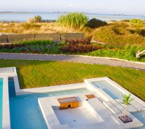 a pool with a table and a bench in a yard at The Retreat Villa in Lefkada