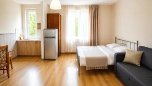 a kitchen with a bed and a couch in a room at Tuz House R6 in Bakuriani