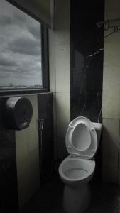 a bathroom with a toilet and a window at the loft residence in Ban Plai Khlong Bang Noi +4 photos