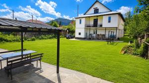 a picnic table on a patio in front of a house at Tuz House R6 in Bakuriani