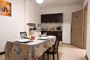 a kitchen with a table with a table cloth on it at Sharon Court Guesthouse in St. Paul's Bay