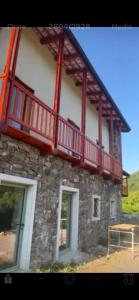 a building with a balcony on top of it at Posestvo Pri žabi in Štanjel