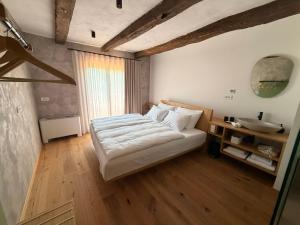 a bedroom with a bed and a sink in it at Posestvo Pri žabi in Štanjel