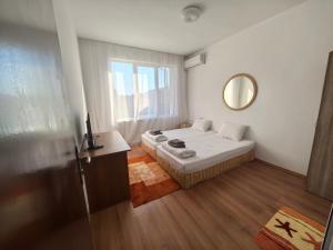 a small room with a bed and a mirror at Стаи за гости Ескейп in Isperikh