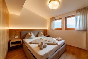 a bedroom with a bed with two towels on it at Krebishof Agriturismo in Schenna +84 photos