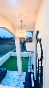 a chandelier hangs from the ceiling of a balcony at Mannat Villa Homestay in Rāmnagar