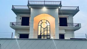 a building with a window on the side of it at Mannat Villa Homestay in Rāmnagar